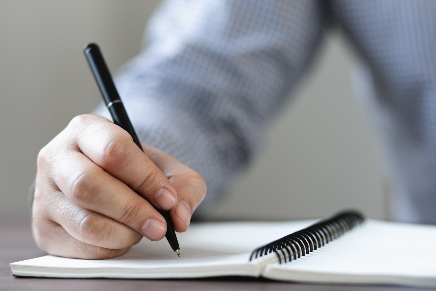 Man Writing on Notebook         